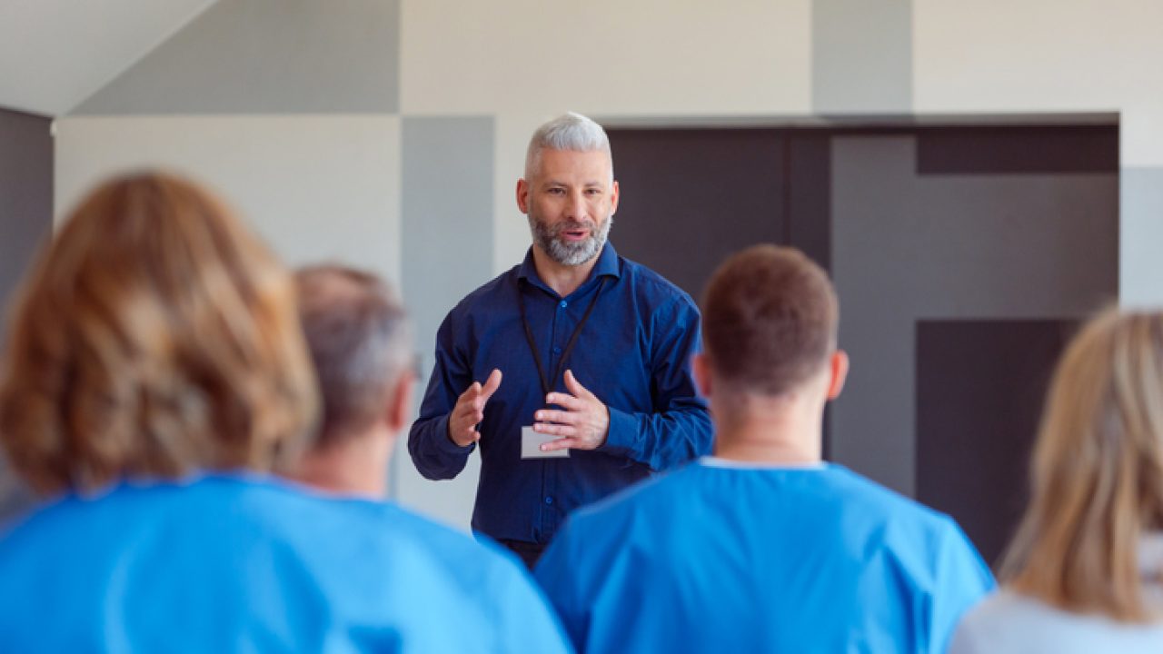 Person coaching a group of students