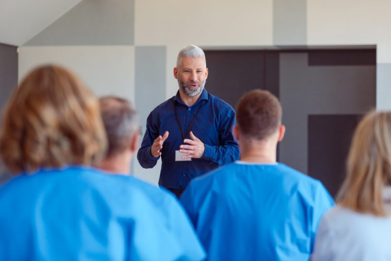 Person coaching a group of students