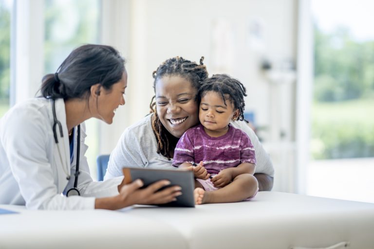 Doctor presenting information to a woman and her child